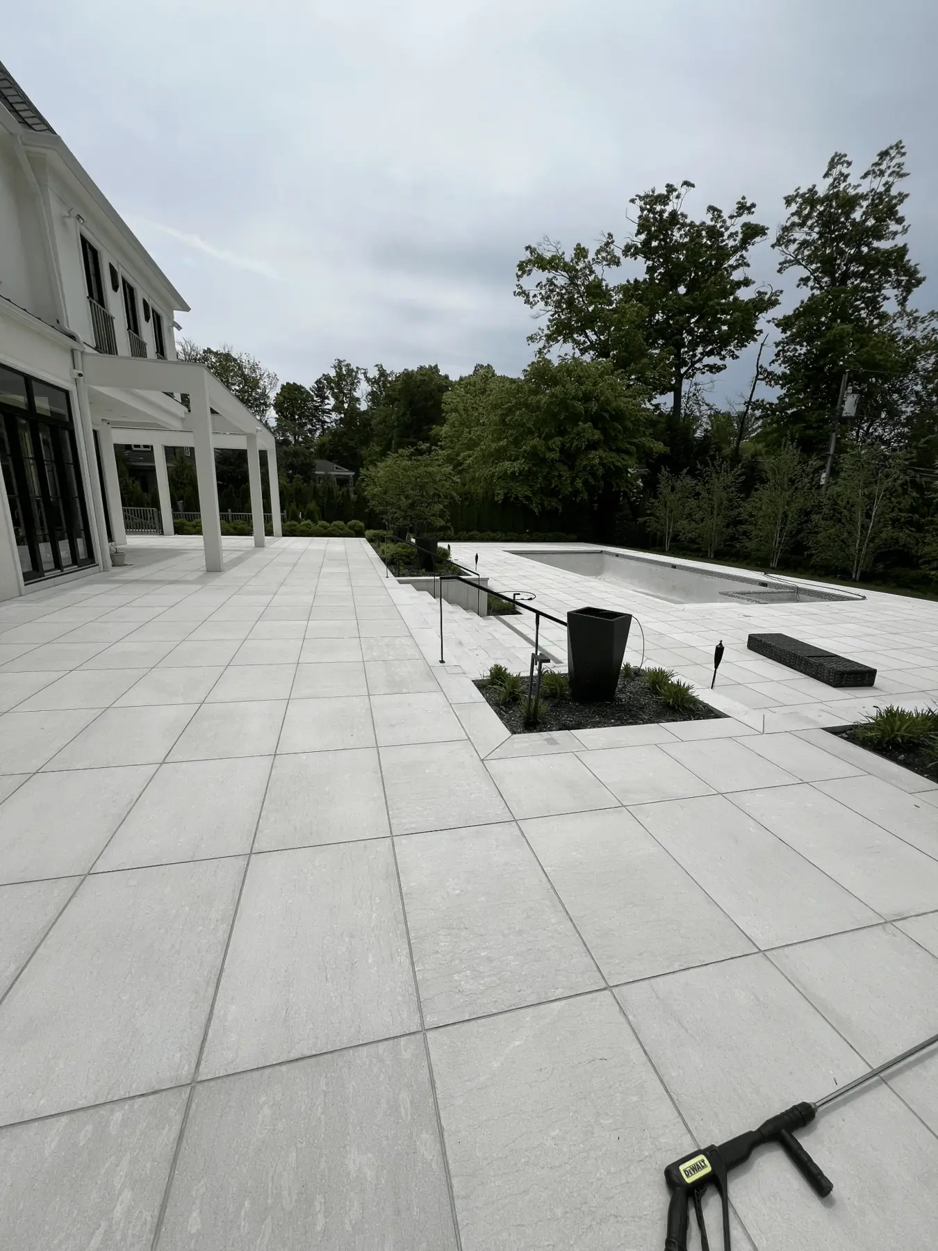 Pale stone pool deck after a low pressure wash